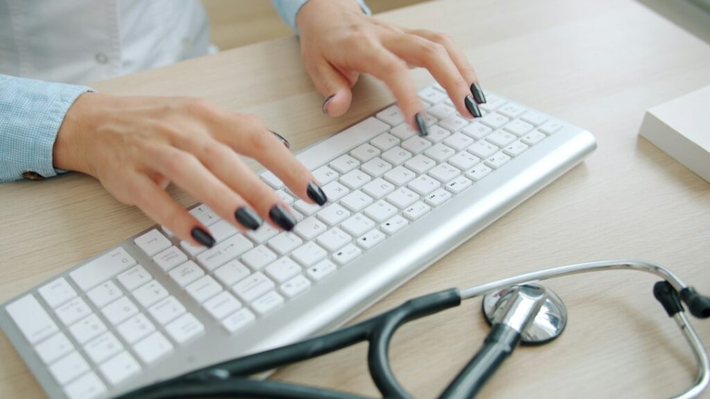 Healthcare professional using a computer during a digital patient journey
